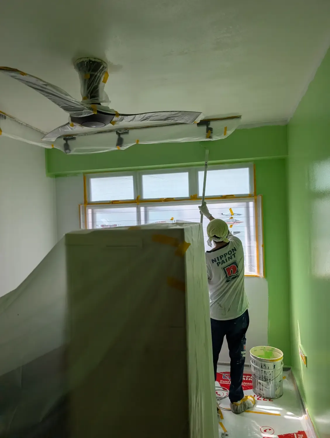 Painting in progress. The fan is placed at the walls that are freshly painted, to get them to dry fast.